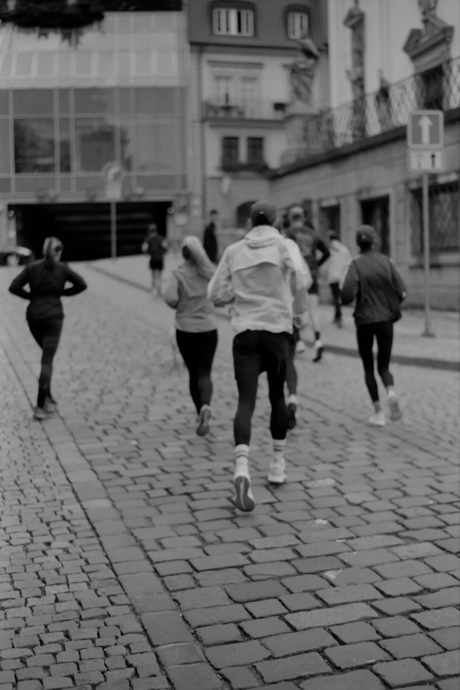 Image of people running down a brick road. Photo by Jeremy Bishop on Unsplash